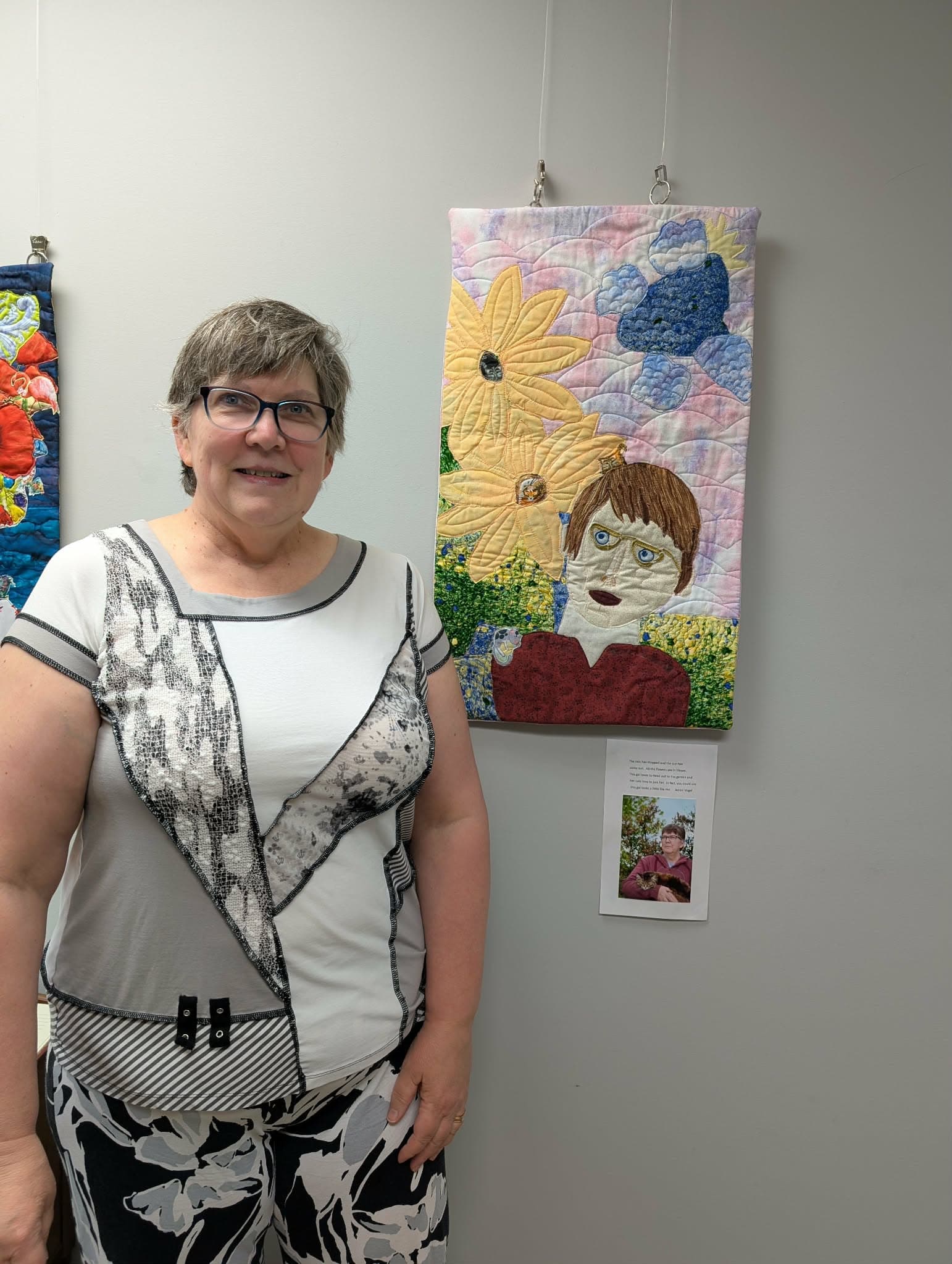 Janice Vogel with her quilted wall hanging
